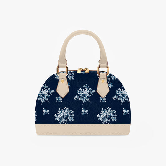 Romantic navy blue floral half moon handbag with delicate vintage-inspired floral print. Small crossbody purse with black or beige handles for casual or formal wear.
